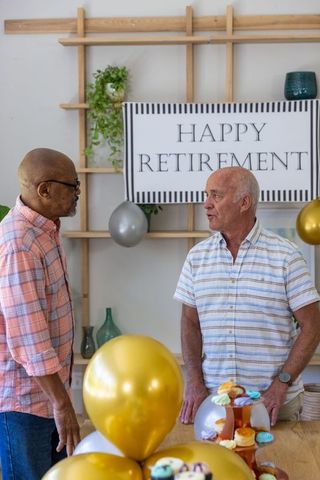 Senior friends chatting at retirement celebration with décor