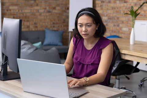 Professional Woman Working on Technology in Modern Office