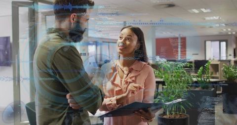 Colleagues collaborating with data visualization overlay in modern open-plan office