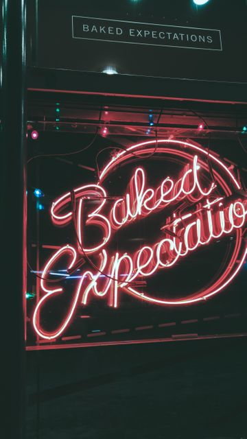 Neon Sign Displaying 'Baked Expectations' in Urban Night Setting - Download Free Stock Photos Pikwizard.com
