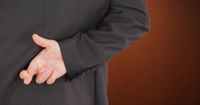 Businessman Crossing Fingers Behind Back Symbolizing Dishonesty - Download Free Stock Photos Pikwizard.com