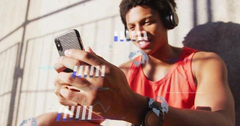Urban Male Checking Data on Smartphone with Headphones
