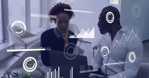 Business Professionals Analyzing Augmented Reality Data on Laptop in Modern Office Lounge