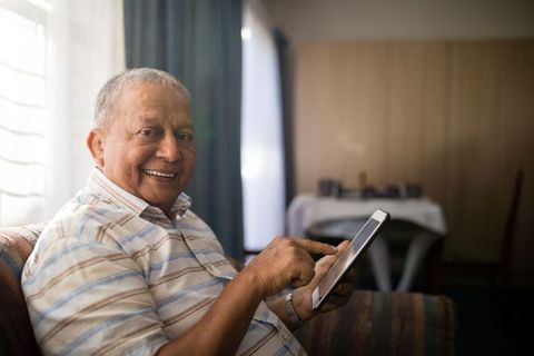 Senior Man Relaxing with Tablet in Cozy Living Room