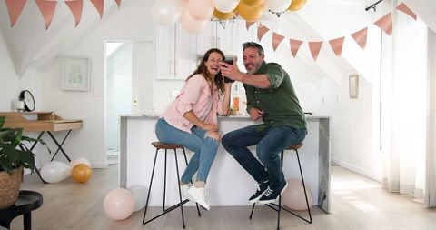 Happy Couple Enjoying Wine and Celebration at Home