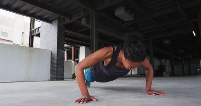 Woman Performing Push-ups in Industrial Setting - Download Free Stock Images Pikwizard.com