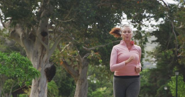 Elderly Woman Jogging in Park Staying Active - Download Free Stock Images Pikwizard.com