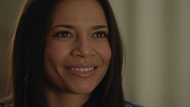 Smiling hispanic woman closeup with dimples and warm beige studio portrait