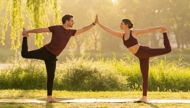 Couple practicing partner dancer pose at sunrise by lakeside park