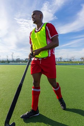 Field hockey player in action on vibrant sunny day