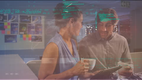 Diverse Coworkers Discussing Technology in Modern Office Environment