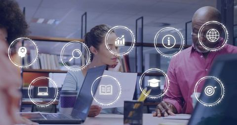 Colleagues Collaborating Over Documents with Digital Analytics Icons and Teamwork Overlay