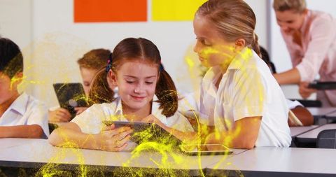Elementary Students Collaborating on Tablets in Classroom with Vibrant Yellow Overlay