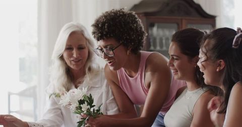 Women collaborating in flower arranging session