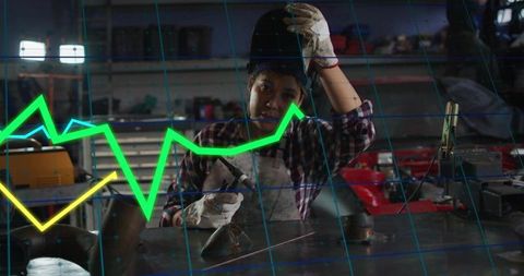 Woman welding at metal workbench with neon graph overlay representing industrial growth