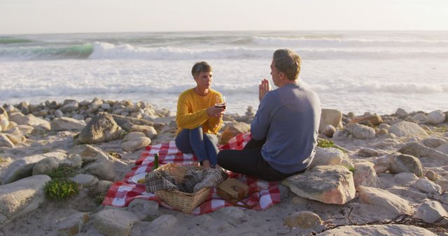 Middle-aged Couple Enjoying Beach Picnic with Ocean Views - Download Free Stock Images Pikwizard.com