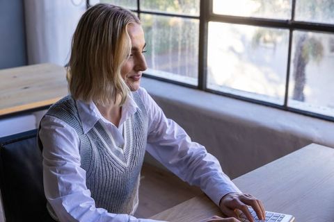 Professional woman working on wireless keyboard in well-lit office