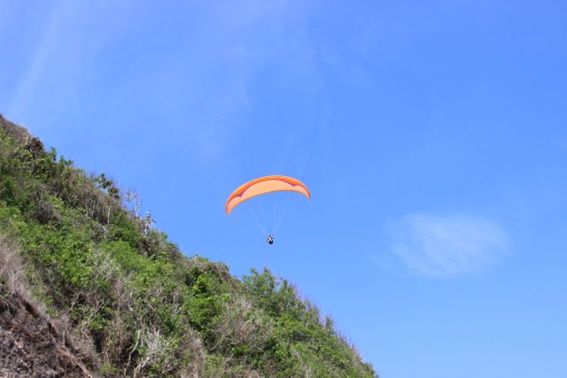 Perfect for advertisements related to adventure sports, travel agencies, tourism promotions, or outdoor equipment brands. This image captures the thrill of paragliding and evokes a sense of freedom and excitement.