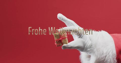 Santa Claus Holding Tiny Gift with 'Frohe Weihnachten' Message on Red