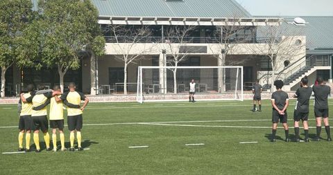 Team Preparation Before Soccer Match Near Goalpost