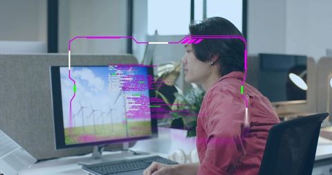 Man in Shirt Writing Code on Desktop at Innovative Office