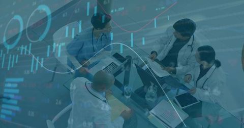 Medical Team Collaborating Over Digital Analytics and Patient Data at Conference Table