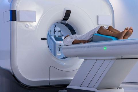 African american patient lying in ct scanner undergoing diagnostic imaging in radiology