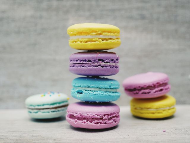 Colorful Macarons Stacked in a Tower on Wooden Surface - Download Free Stock Photos Pikwizard.com