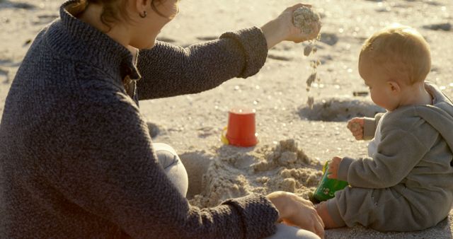 Mother and Infant Playing in Sand at the Beach - Download Free Stock Images Pikwizard.com