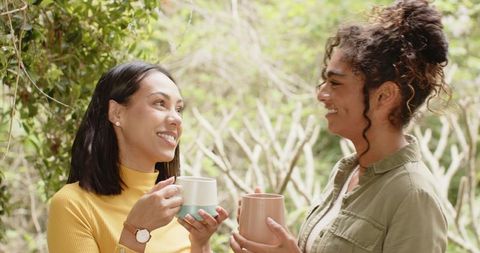 Women Relaxing with Coffee in Cozy Backyard