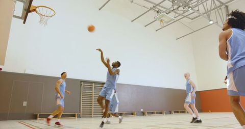 Group of Male Basketball Players Shooting on Indoor Court