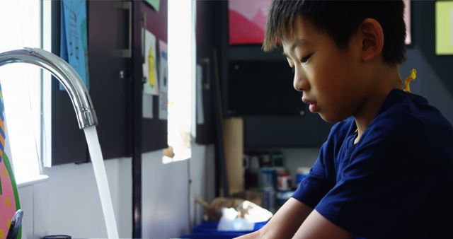 Young Boy Washing Hands at Sink in Art Classroom - Download Free Stock Images Pikwizard.com