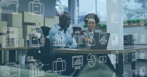 Business professionals analyzing data with futuristic graphics overlay