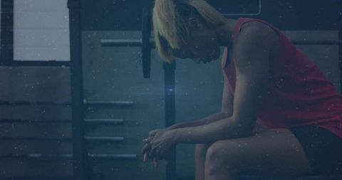 Contemplative Athlete Sitting on Bench After Weightlifting Session in Moody Gym Power Rack