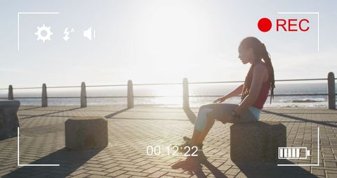 exhausted athlete resting at oceanside promenade during sunset - Download Free Stock Images Pikwizard.com