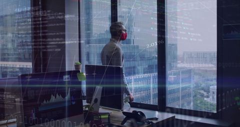 Businessman observing financial data during pandemic in office