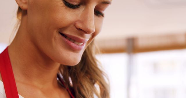 Woman Smiling in Kitchen with Red Apron - Download Free Stock Images Pikwizard.com