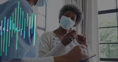 Geriatric patient discussing medical treatment with nurse in clinic