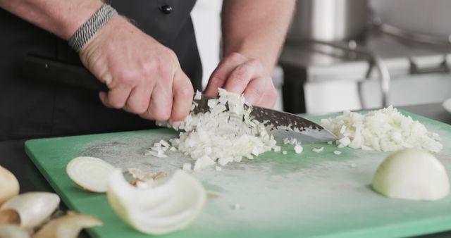 Chef Chopping Onion on Green Cutting Board in Professional Kitchen - Download Free Stock Images Pikwizard.com