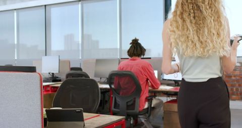 Colleagues Collaborating in Open Workspace for Project Discussion