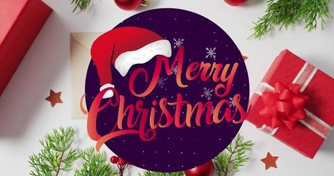 Merry christmas badge with santa hat on flatlay of red gifts, evergreen decor