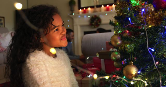 Young Girl Admiring Decorated Christmas Tree with Holiday Lights - Download Free Stock Images Pikwizard.com