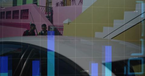 Young men standing behind sedan by colorful houses with blue data visualization overlay