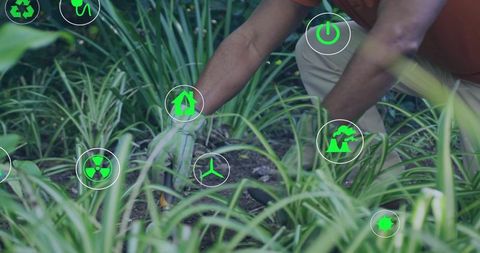 Kneeling gardener tending soil with green sustainability icons and renewable energy symbols