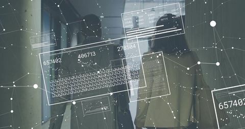 Business colleagues walking in corridor with digital data overlay and network analytics