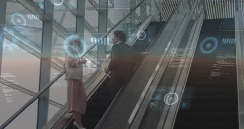 Business Professionals Integrating Digital Technology on Escalator