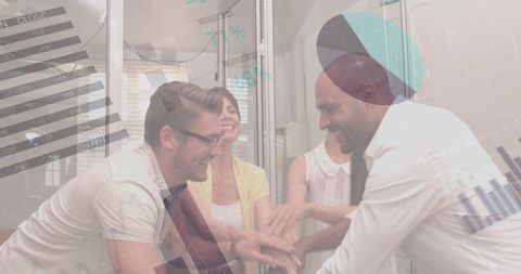 Team celebrating success with high-fives in office