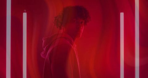 Stylish Man in Red Lighting with Neon Tubes