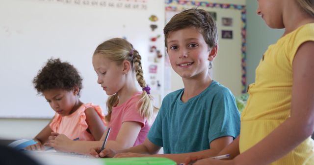 Smiling Boy and Classmates Studying in Classroom - Download Free Stock Images Pikwizard.com