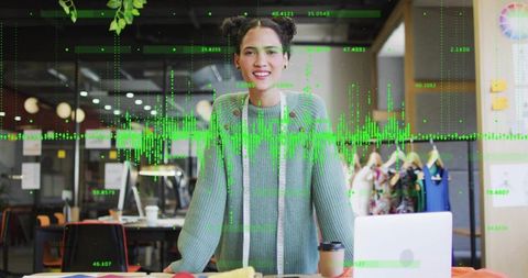 Fashion designer smiling in creative studio measuring fabrics